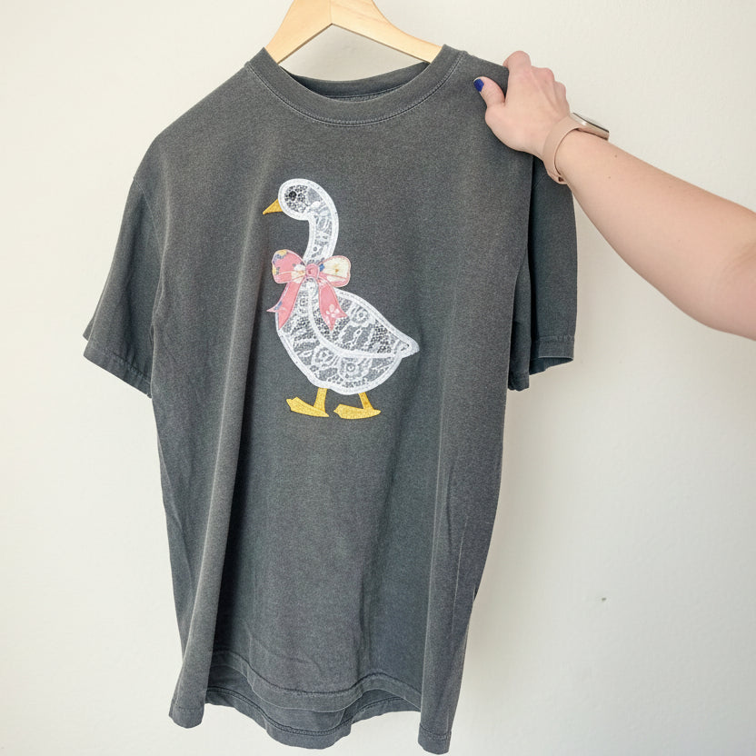 Gray t-shirt with a goose graphic design on a white background