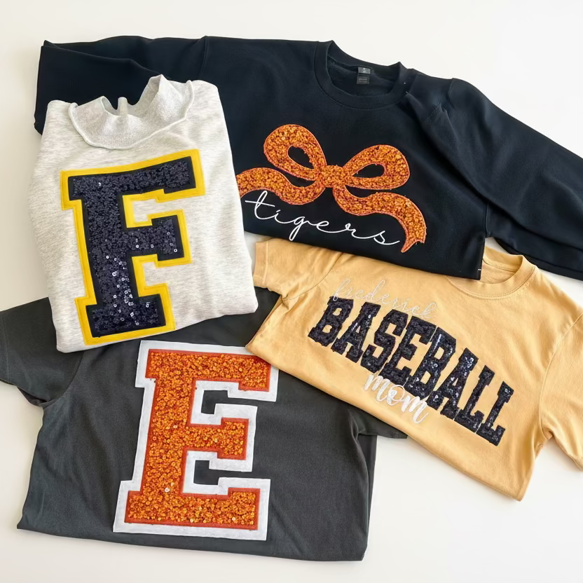 Collection of t-shirts with decorative text and graphics on a light background