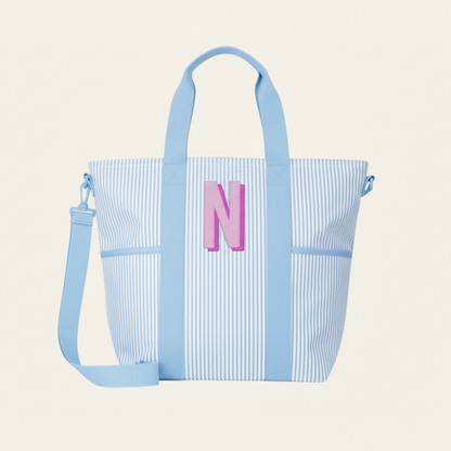 Blue striped tote bag with a pink letter &