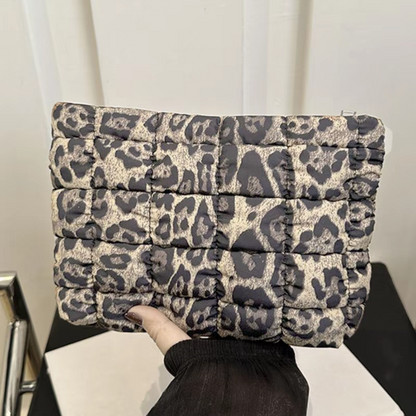 Leopard print pouch on a white surface with a black background
